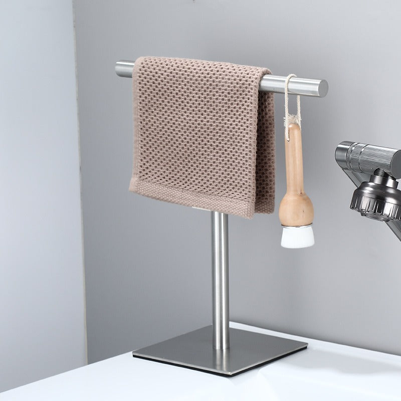 Havlin towel holder in brushed steel beside a basin with a hand towel