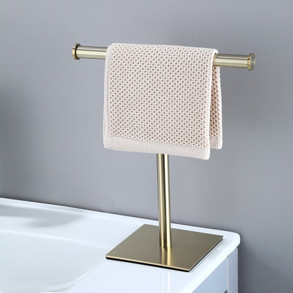 Havlin towel holder in brushed gold beside a basin with a hand towel