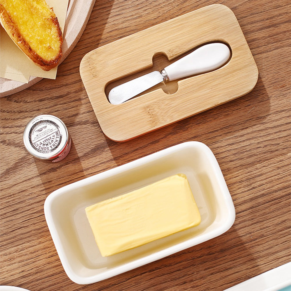 Kremora butter dish on a table with toast and the lid alongside