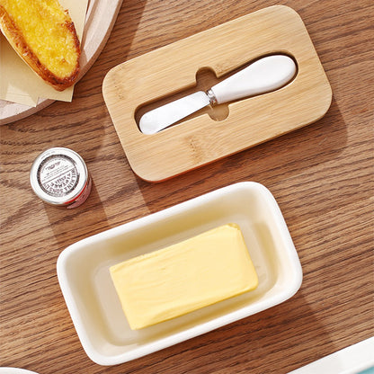 Kremora butter dish on a table with toast and the lid alongside
