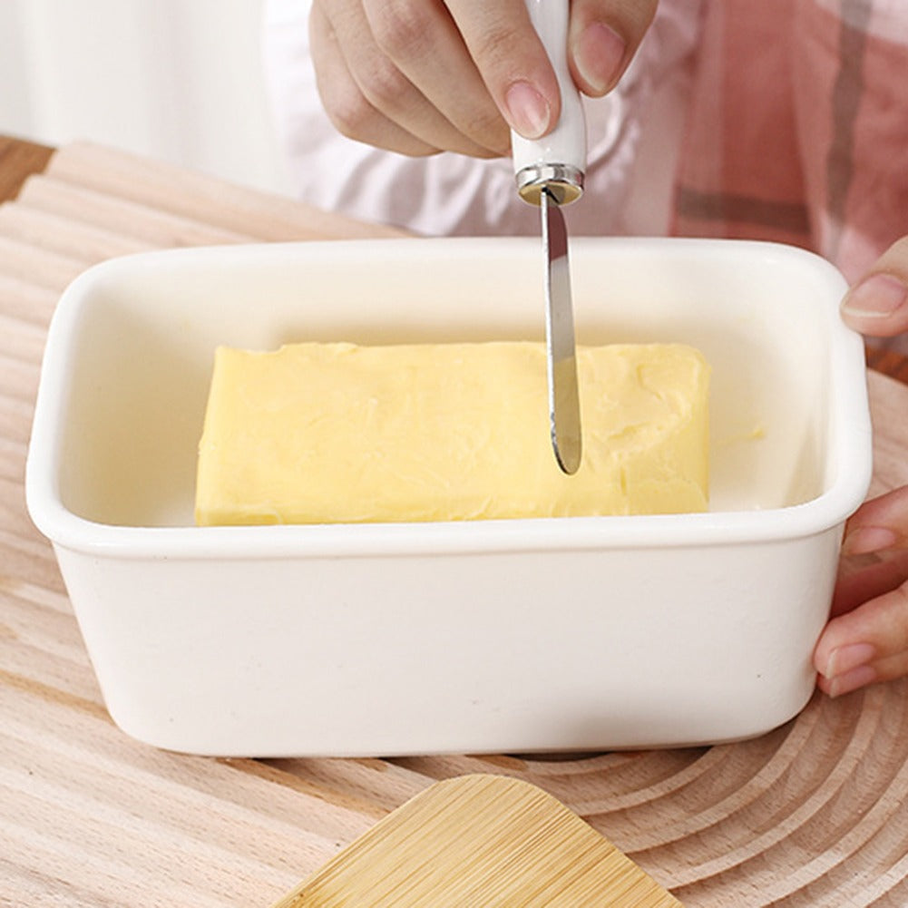 Butter being taken from the Kremora dish with the included spreader
