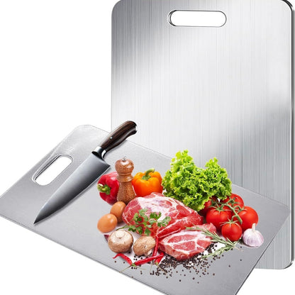Inoxa stainless steel cutting board with a knife and fresh produce