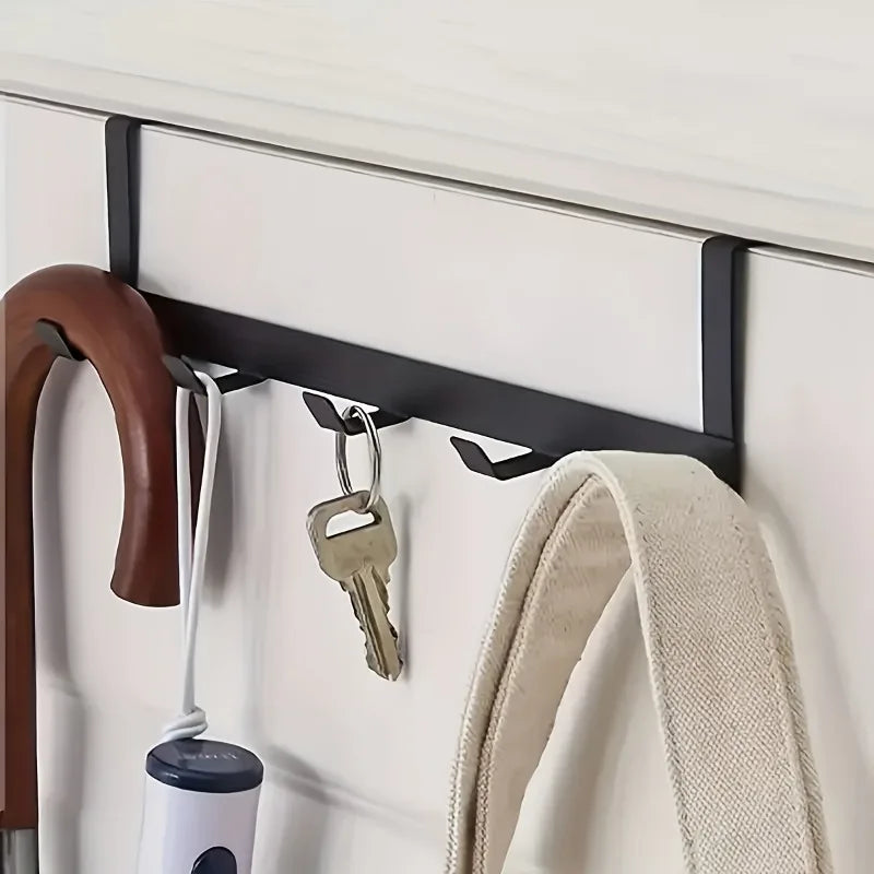 Close-up of an umbrella, keys and a bag on the Doorvia hooks