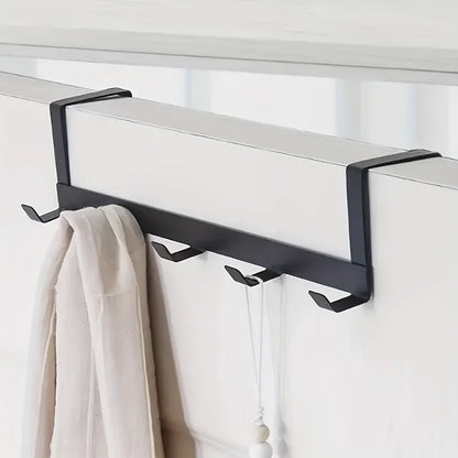 Doorvia rack behind a door with towels and a scarf