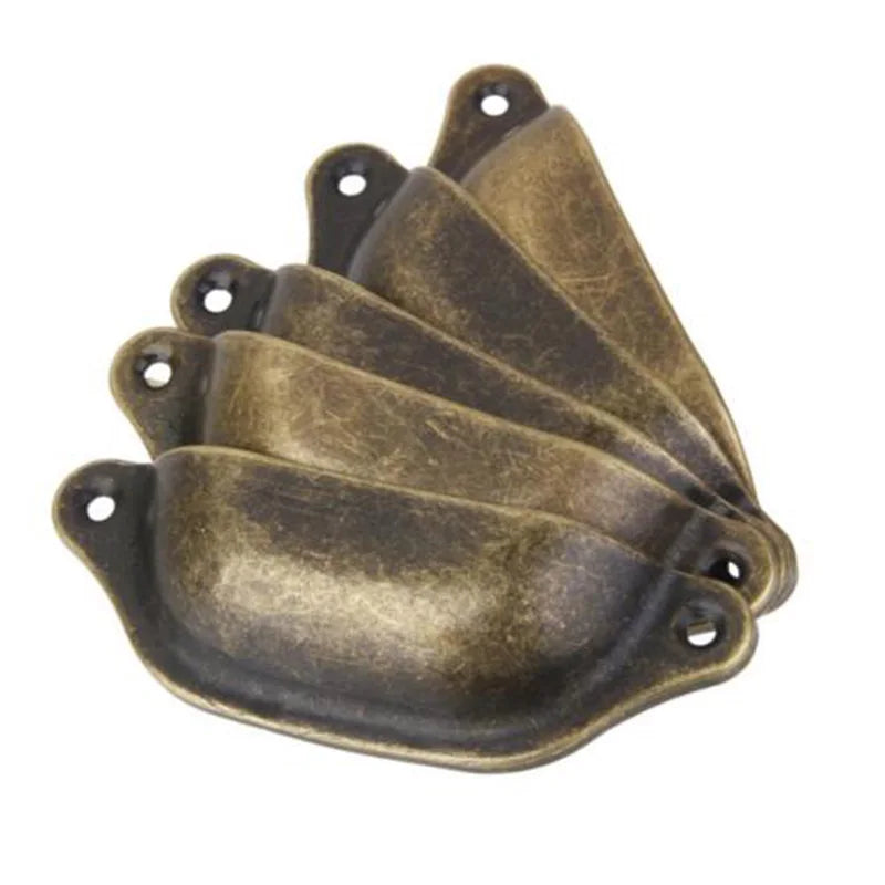 Antique brass-tone cup pull handles shown at an angle