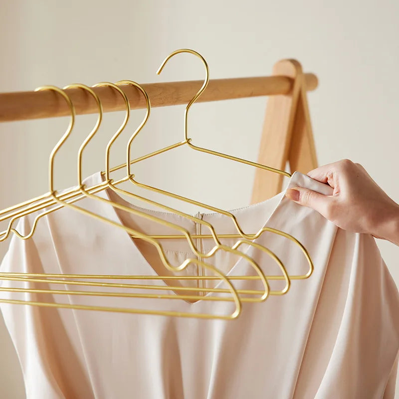 Aluvia gold hangers on a wardrobe rail
