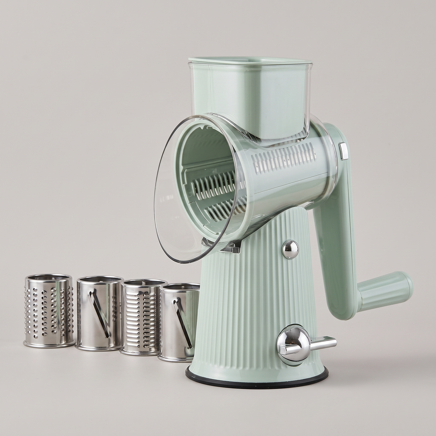 Gratino rotary grater with its five stainless drums on a plain backdrop