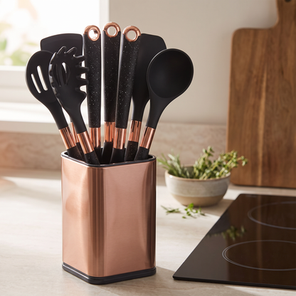 Silixa silicone utensil set standing in its rose gold holder on a kitchen worktop