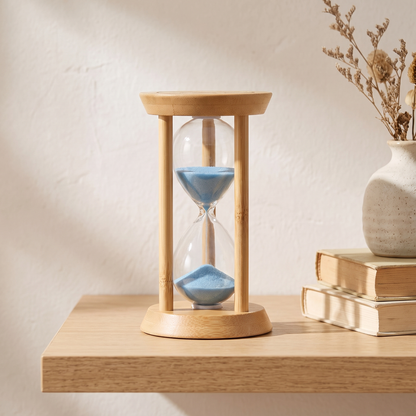 Zandra bamboo sand timer - on a shelf with books and a ceramic vase